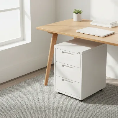 Poppin White 3-Drawer Stow File Cabinet neatly tucked under a modern office desk with documents and supplies